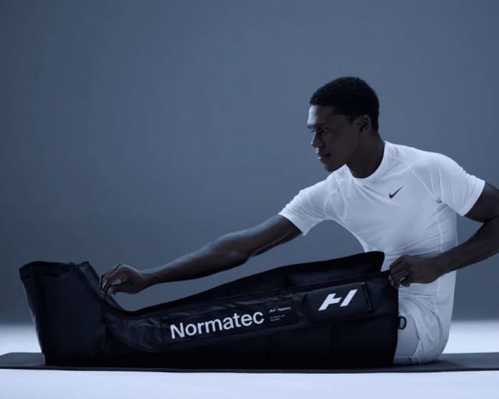 man using leg compression therapy