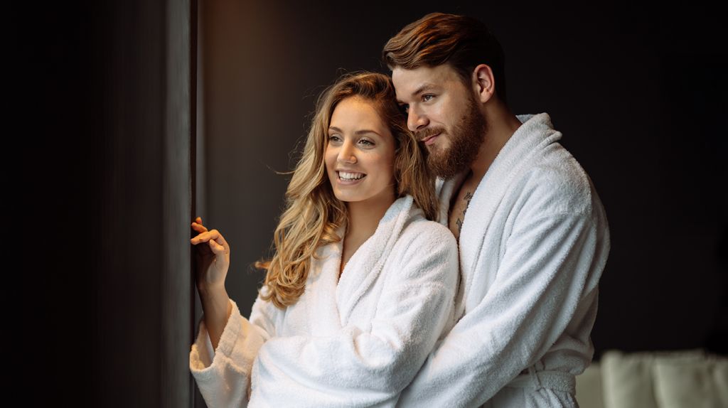 couple wearing robes enjoying a relaxing date night in Cleveland