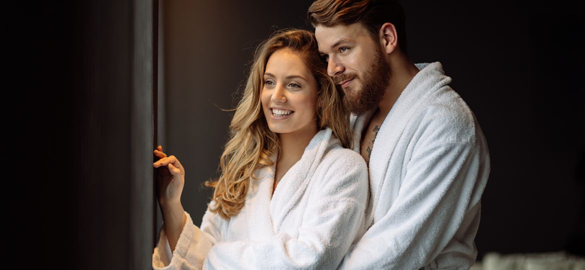 couple wearing robes enjoying a relaxing date night in Cleveland