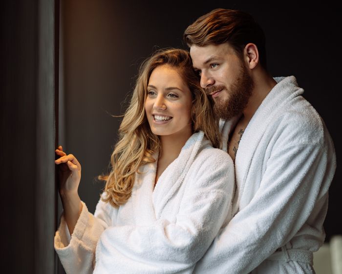 couple wearing robes enjoying a relaxing date night in Cleveland