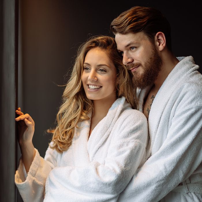 couple wearing robes enjoying a relaxing date night in Cleveland
