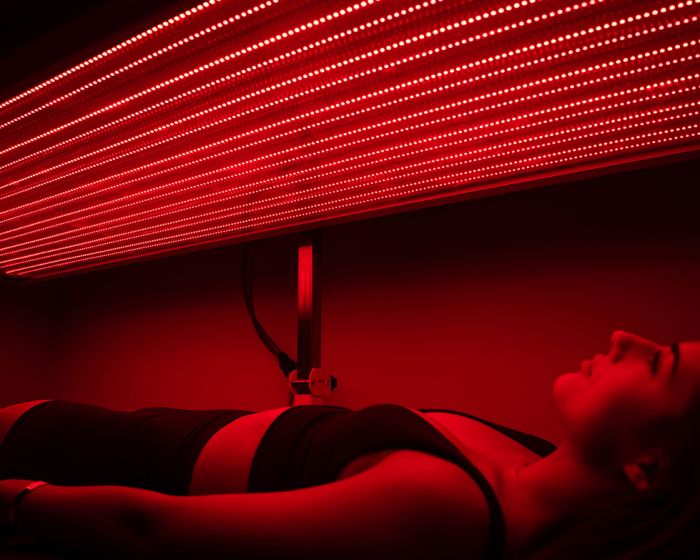 woman in red light therapy session in cleveland