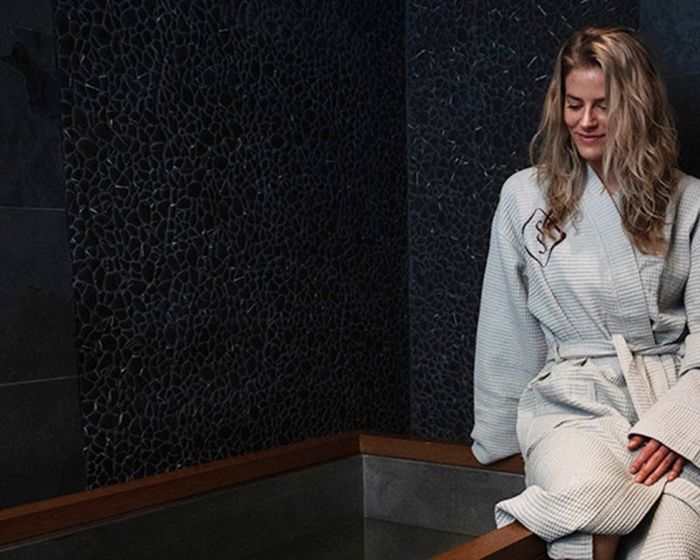 woman in robe enjoying contrast therapy in Cleveland