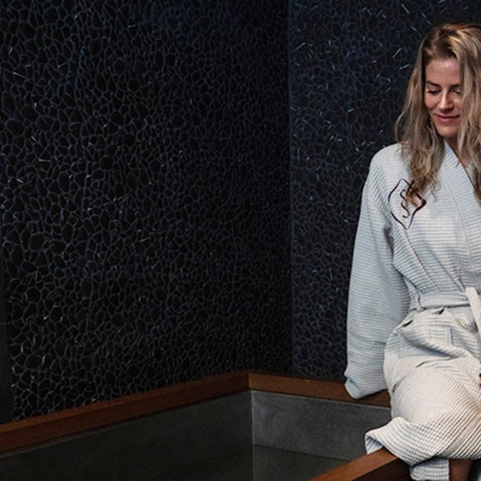 woman in robe enjoying contrast therapy in Cleveland