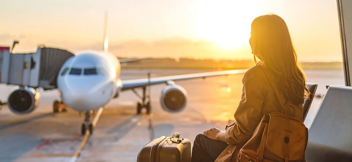 woman with bags at Cleveland airport considering layover wellness experiences