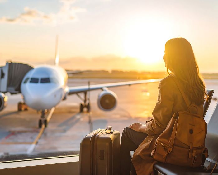 woman with bags at Cleveland airport considering layover wellness experiences