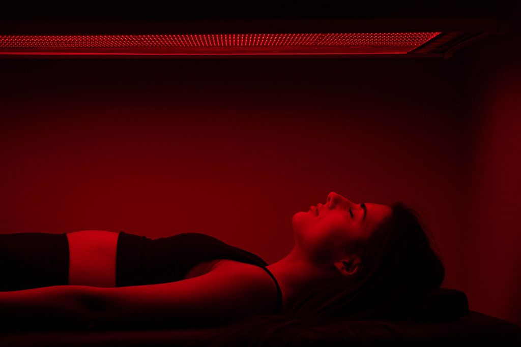 woman with eye closed experiencing full body red light therapy at SoulSpace Cleveland