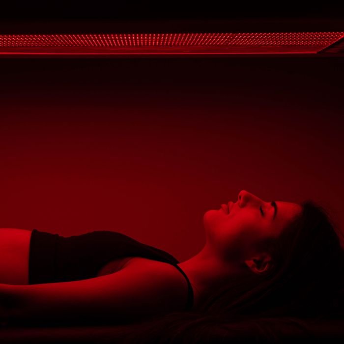 woman with eye closed experiencing full body red light therapy at SoulSpace Cleveland